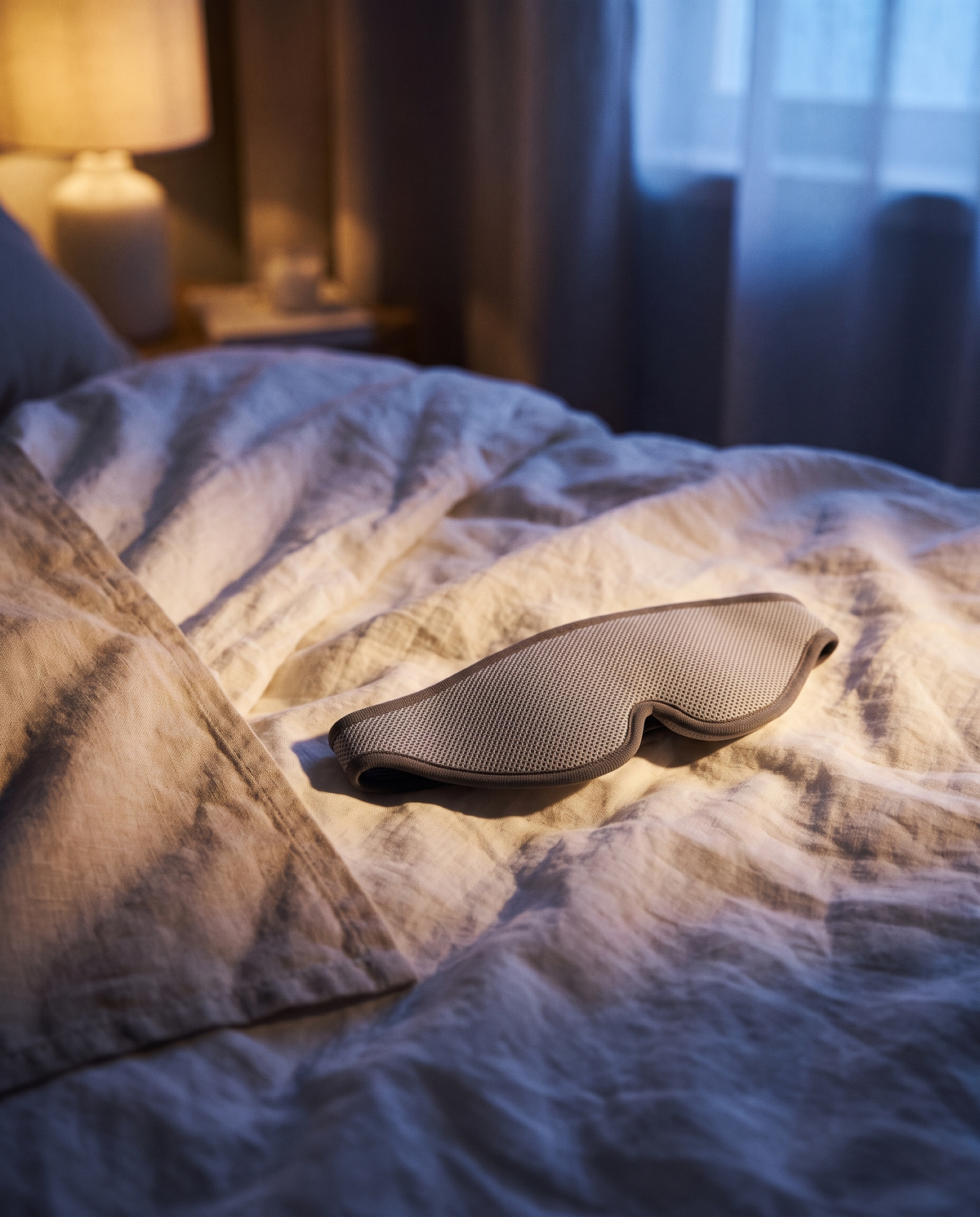Le masque 3D occultant posé sur un drap de lin crème
